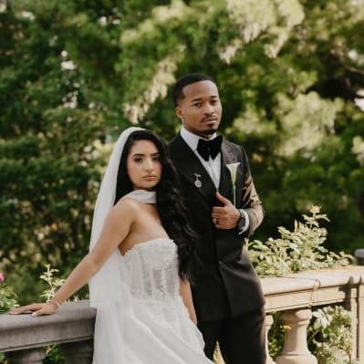 Jenny and Joseph pose side by side in their wedding attire at Villa Terrace