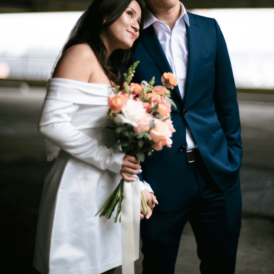 Bride Holding Bouquet and Resting Head on Husband's Shoulder