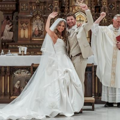Tess and Tommy wave to their friends and family after exchanging vows 
