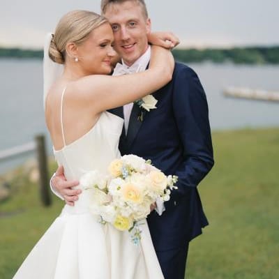 Grace and Lucas embrace with the lake in the background