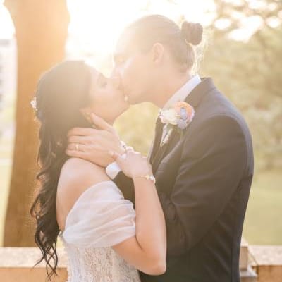 Grant and Shipra pose with golden hour sun illuminating them 