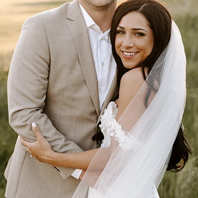A Minnesota bride and groom embrace and smile at the camera