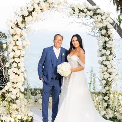 Experience the elegance of Tiana Belle and Todd Bryant’s wedding as they exchange vows at the altar, surrounded by an ethereal all-white setup and vibrant floral accents at Gulls Way.