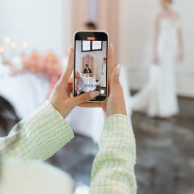 Content creator taking candid video of a bride