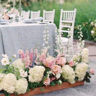Bright florals in front of classic tablescape at Fox Hollow Farms