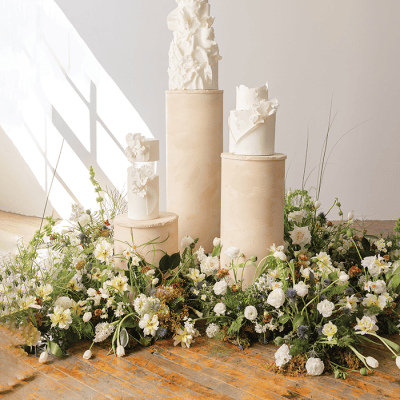 Chic and Elegant Wedding Cakes Displayed Amongst Fresh Florals