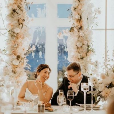 Lauren and William Share a Smile Surrounded by Whimsical Florals