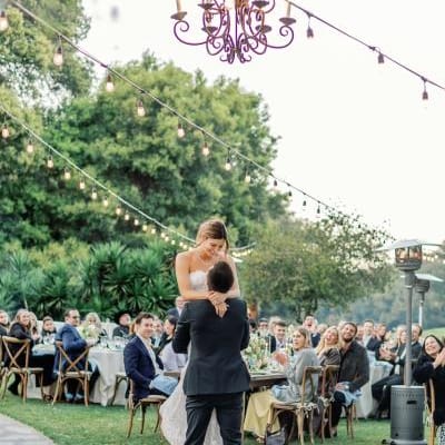 Dakoda and Colette Share a Sweet Moment During their First Dance Under Bulbed Lights at Charming Outdoor Affair at Temecula Creek Inn
