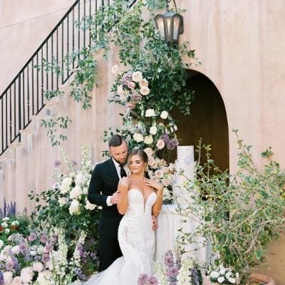 Couple Posing in Opulent and Airy Styled Shoot at Silverleaf Country Club featuring Elegant Pastel Florals