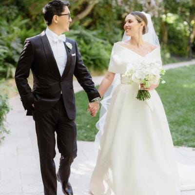 NBC Southern California newscaster Ted Chen and his bride, Ariell Kirylo, walk hand in hand through the lush gardens of Hotel Bel-Air, glowing with joy on their wedding day.