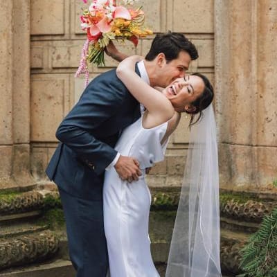 Bright colored florals decorate ecclectic wedding held under the roman rotunda at the Palace of Fine Arts