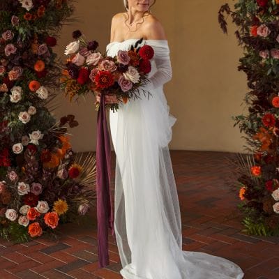 Autumn-inspired wedding shoot at a Tuscany-style winery with rich florals, warm tones, and elegant details.