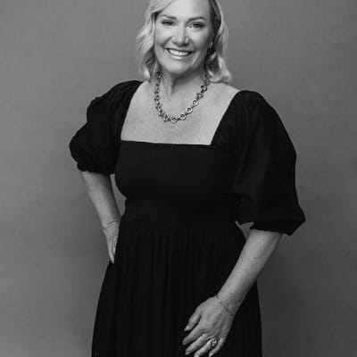 Headshot of Editor Lara Burnap smiling, in black and white