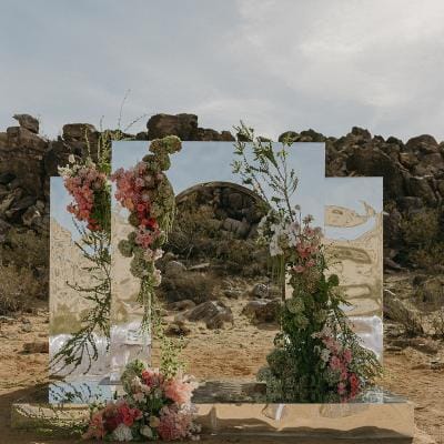 Eclectic desert ceremony space with mirrored altar and vibrant florals at Morada in Joshua Tree