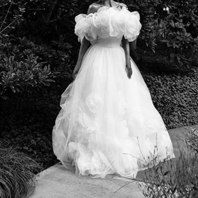 Model Kami Buchanan poses in the middle of a sidewalk in avante garde off the shoulder gown at Lauritzen Gardens