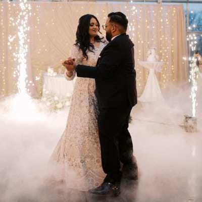 Bride and groom share their first dance accompanied by fog and cold sparks