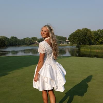 Bride walking on golf course in her mother's reworked bridal gown