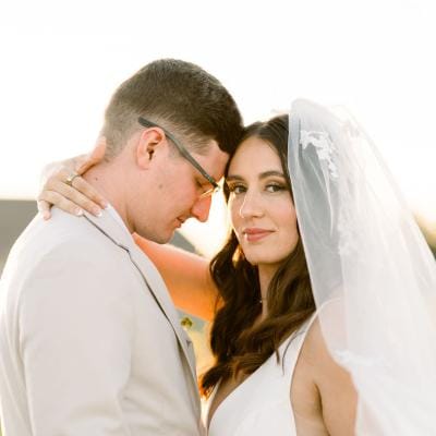 Close up of the bride and groom in an embrace with their foreheads pressed together on the grounds of Bella Terre Vineyard