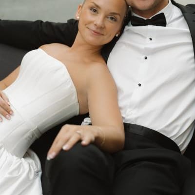 Bride leans on the shoulder of her groom, lounging on their wedding day at The Joslyn