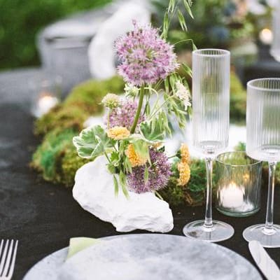 Place setting on moody detail-oriented tablescape and Grand View Malibu 