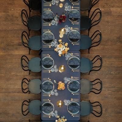 Bold tablescape featuring dark navy tones and metallic accents in one long table at Ellsworth Block