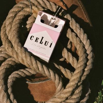 Celui promotional photo with fragrance pack sitting in a bundle of rope