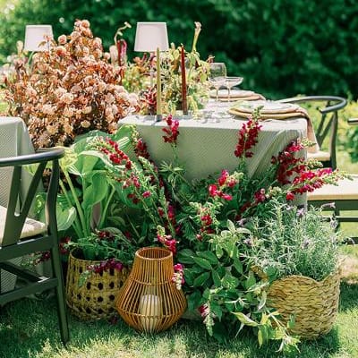Lush blooms overflow from circular tablescape in editorial at Parties on the Terrace