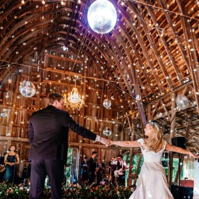 Bride and groom dance together covered in disco lights in reception at Arbor Day Farm 