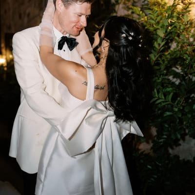 Bride and groom embrace in their after-party attire in wedding day at Monserate Winery