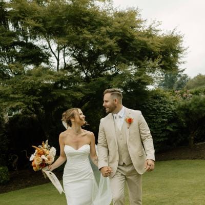 Sarah and Josh walk the grounds of the bride's childhood home on their lakeside wedding day