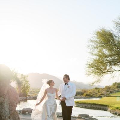 Emily and Vladimir cross the grounds of The Reserve Club during golden hour on their wedding day