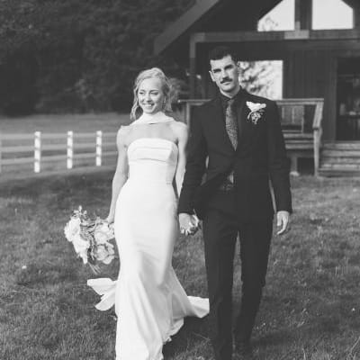 Ashley and Jaxson walk hand in hand on the grounds of Wind Mountain Ranch