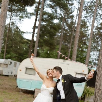Molly and Ralph pose with their ice cream cones on their wedding day at Camp Elsewhere