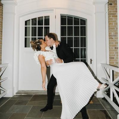Jack dips Abby into a kiss in their lakeside wedding day at a private residence