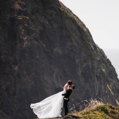 Olivia and Bryan kiss on the coast of Oregon 