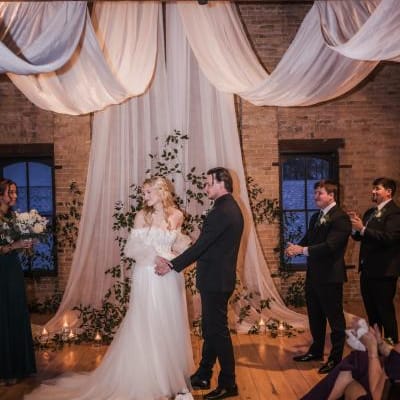 Elizabeth and Matthew standing at the altar on their wedding day at The Lageret