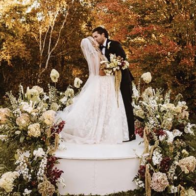 Morgan and Justin kiss at the altar in their wedding day at The Farm Wedding and Event Center