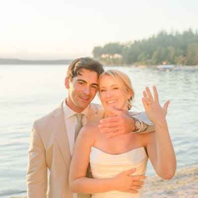 Courntey and Alden pose by the lake on their wedding day
