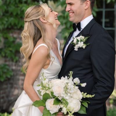 Anna and Grant share a laugh at their lakeside wedding day
