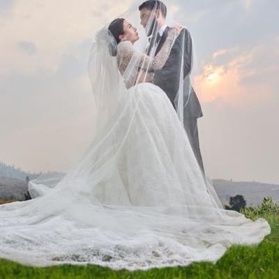 Noelle and Richard embrace as the sun sets behind them on their wedding day at Larc Hill Vineyard
