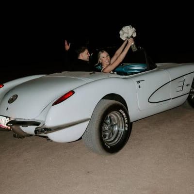 Madison and Sam in their vintage getaway car