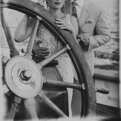 Kelsey and Gawan pose at the helm of Schooner Zodiac on their wedding day