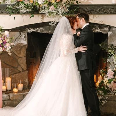 Lilly and Michael share a kiss on their wedding day at Chateau Lil