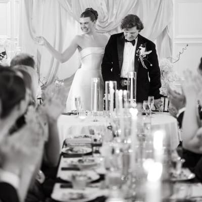 Natalie and Trip laughing at the head table of their reception at St. Paul College Club 
