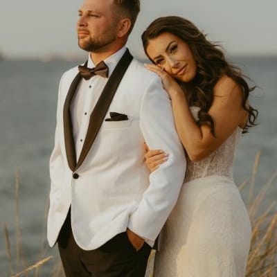 Laney rests her head on Troy's shoulder in their wedding attire 