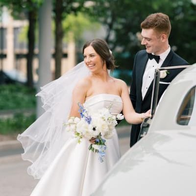 Meredith and Daniel enter their vintage getaway car in their wedding day attire