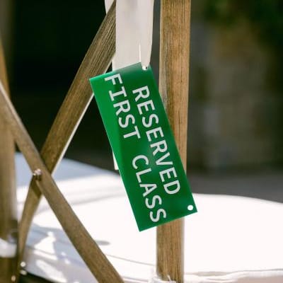 Aviation themed escort card hanging on chair