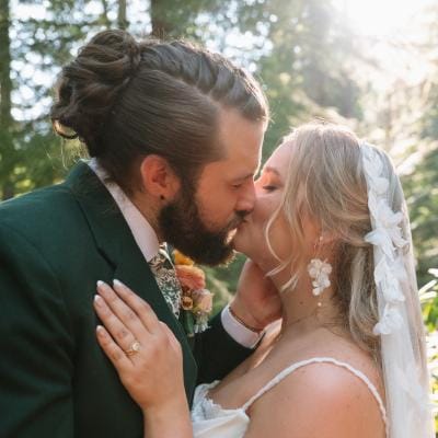 Natasha and Will share a kiss on their wooded wedding day