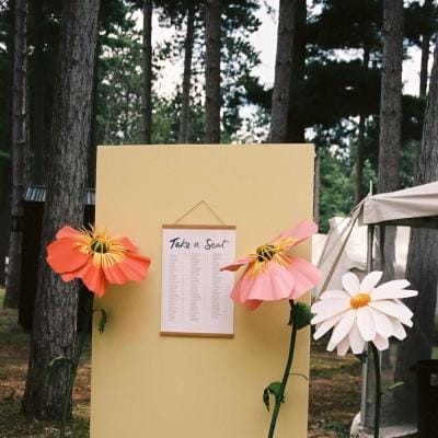 Handmade paper florals around seating chart 