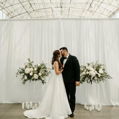 Lauren and Nathan share a kiss at the altar on their wedding day at Greenhouse No 7